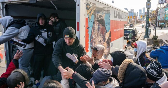 A hot Christmas meal and an anonymous donor with a U-hall full of warm clothes deliver the spirit of holiday giving